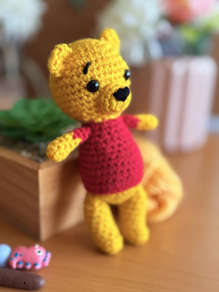 handmade crochet bear toy inspired by Winnie the Pooh with red shirt and warm smile